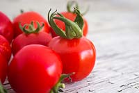 Tomato 'Gardener's Delight' on wooden surface