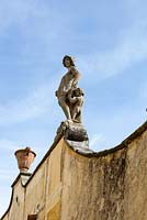 Painted stucco wall to side of the Villa and Bowling Green. Villa Gamberaia, Settignano, nr Florence, Tuscany, Italy. Septrmber. 