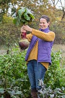 Woman holding a giant overgrown beetroot