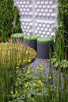 Cylinder stools with green cushions next to a modular living wall, Equisetum hyemale in the foreground with Trollius x cultorum