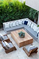 View of built in seating area with chairs table and soft furnishings. 