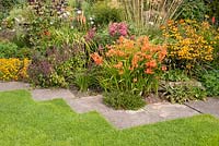 Border with Crocosmia 'Severn Sunrise' Crocosmia 'Gerbe D'Or' Achillea millefolium 'Red Velvet' Stipa gigantea Teucrium hircanum Kniphofia 'Alcazar' and Helenium 'Moerheim Beauty' September 