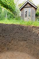 Soil profile showing topsoil and sub-soil. Hole excavated to depth of 60cm