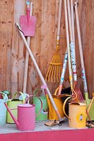 Store for childrens' gardening equipment, including trowels, rakes, spades and watering cans