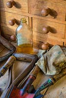 Garden workbench, with wooden handled garden tools being treated with linseed oil.