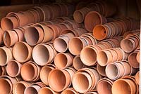 Piles of terracotta pots stored in a shed at West Dean Kitchen Gardens, West Sussex