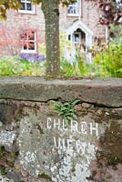 The house name is incised in the sandstone of the front wall.