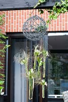 Hanging ornamental wire ball with Agapanthus White flowers. Family Fabry - Mathijs. Belgium