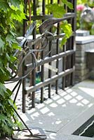 Iron Heron near the pond. Trellis with climbing grape. Family Fabry - Mathijs. Belgium