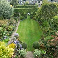 Aerial view of formal town garden in summer with box topiary, pleached field maples. September