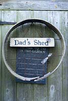 Vintage garden sieve hanging on shed door with Dad's Shed sign and Union Jack heart. June