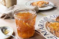 A jar of Marmalade with a breakfast setting