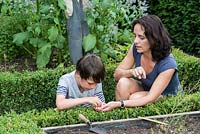 Dawn Isaac gardening with her 9 year old son, Oscar.