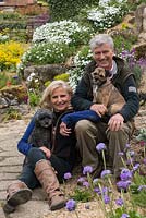 In the rockery at Alswick Hall, owners Mike and Annie Johnson with Ivy, a Highland terrier, and Twiglet, a miniature poodle.