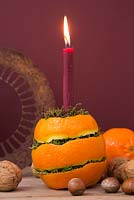 A candle holder made from Orange peel and moss