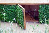 Under-deck storage space in the 'Urbanise' garden. The RHS Hampton Court Flower Show, 2009, designed by Ian Rochead