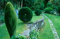 Astrotuf spiral, disc and heart by sculptor Lucy Strachan, positioned alongside the vegetable patch in her garden