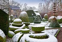 Topiary shapes and characters with a covering of snow at Levens Hall and Garden, Cumbria, UK. 