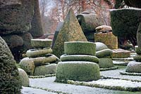 Topiary shapes and characters with a dusting of snow at Levens Hall and Garden, Cumbria, UK. 