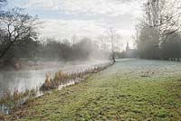 Mist rises from the River Lambourn that runs through the grounds of Welford Park, Newbury, Berks, UK