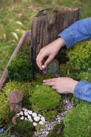 Miniature Wheelbarrow Garden. Adding animal figurines to the miniature garden