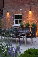 Enclosed patio dining area with table prepared and downlight lighting