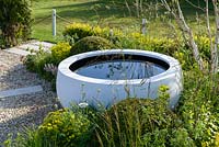 Water bowl by Urbis surrounded by Euphorbia and Buxux balls - Time is a Healer supporting Primrose Hospice, RHS Malvern Spring Festival 2016. Design: Wilson Associates Garden Design. Bronze Medal and People's Choice Award