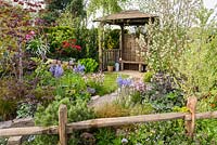 Mixed planting with Camassia esculenta 'Quamash' , Corylus, Lychnis flos cuculi 'Terry's Pink' and Pinus. The Water Spout Garden, RHS Malvern Spring Festival 2016. Best Festival Garden. Silver Gilt. Design: Christian Dowle