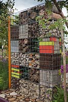Gabions filled with natural and recycled objects as decorative feature and wildlife habitat. Garden: 'Nature Squared' at RHS Tatton Park Flower Show 2012