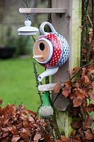 Birdhouse made from colourful teapot