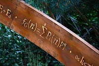 Detail of illuminated mathematical symbols cut into band of copper to form bannister for staircase leading up the belvedere in the Winton Beauty of Mathematics,Chelsea Flower Show 2016.