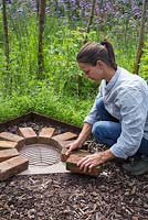 Placing bricks in position using the grill as a guide