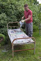 Water the newspaper and cardboard until they are well soaked