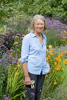 Susie Pasley-Tyler beside the orange, purple and blue border which peaks in September, at the bottom of the garden.