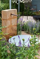 A water feature in a gravel bed planted with Echinacea, perovskia and veronicastrum. A Retreat Garden designed by Martin Royer.