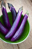 Chinese aubergines in a green bowl. Eggplant