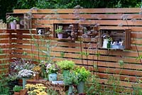 Katie's Garden. Cut flowers in wooden crates hung on timber fencing. Designers: Carolyn Dunster and Noemi Mercurelli. Sponsors: Katie's Lymphoedema Fund. RHS Hampton Court Palace Flower Show 2016