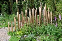 Wooden fence in a cottage garden'Nous irons tous au jardin' designed by Laurent Dabomprez and Gaelle Van Damme at the Festival International des Jardins 2016, Chaumont-sur-Loire, France