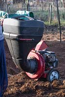 Petrol driven garden shredder being used to break up the content of used Gro Bags