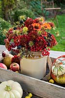 Autumn flower arrangement inc chrysanthemums, zinnias, blackberries, sorbus berries and clematis seedheads