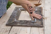 Attatching L brackets onto planks to hold frame together