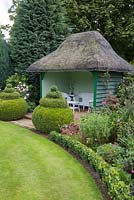 Summer house with box topiary at entrance
