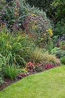 Mixed border planted with Verbena bonariensis, Heucheras and ornamental grasses