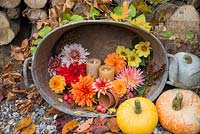 Arrangement in stainless steel basin containing lit candles, Malus, Pumpkins and a variety of cut Dahlias