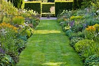 Summer borders of perennials and grasses. Rudbeckia fulgida 'Goldsturm', Gaura lindheimeri, Agastache 'Blue Fortune', Echinacea purpurea 'Fragrant Angel', Solidago 'Goldenmosa', Phlox paniculata, Kalimeris incisa, Salvia nemorosa 'Caradonna', Echinops ritro, Hydrangea paniculata, Echinacea 'Green Jewel'.