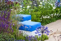 Blue seats surrounded by perennial planting including salvia and white cosmos. Noble Caledonia garden, Spirit of the Aegean, RHS Hampton Court Palace Flower Show 2015. Designed by Esra Parr
