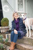 Annie Stanford with three year old whippet Flynn on the platform of the railway carriage