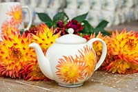 A glazed teapot, hand decorated with a design based on Dahlia 'Alfred Grille'.