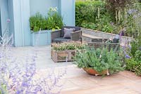 Paved seating area with Linaria purpurea 'Canon Went' in a shallow container, wooden crate planted with Erigeron karvinskianus - Viking Cruises World of Discovery Garden, RHS Hampton Court Palace Flower Show 2017