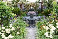 Crazy paving path leading to decorative water fountain - Great Gardens of the USA The Charleston Garden, RHS Hampton Court Palace Flower Show 2017